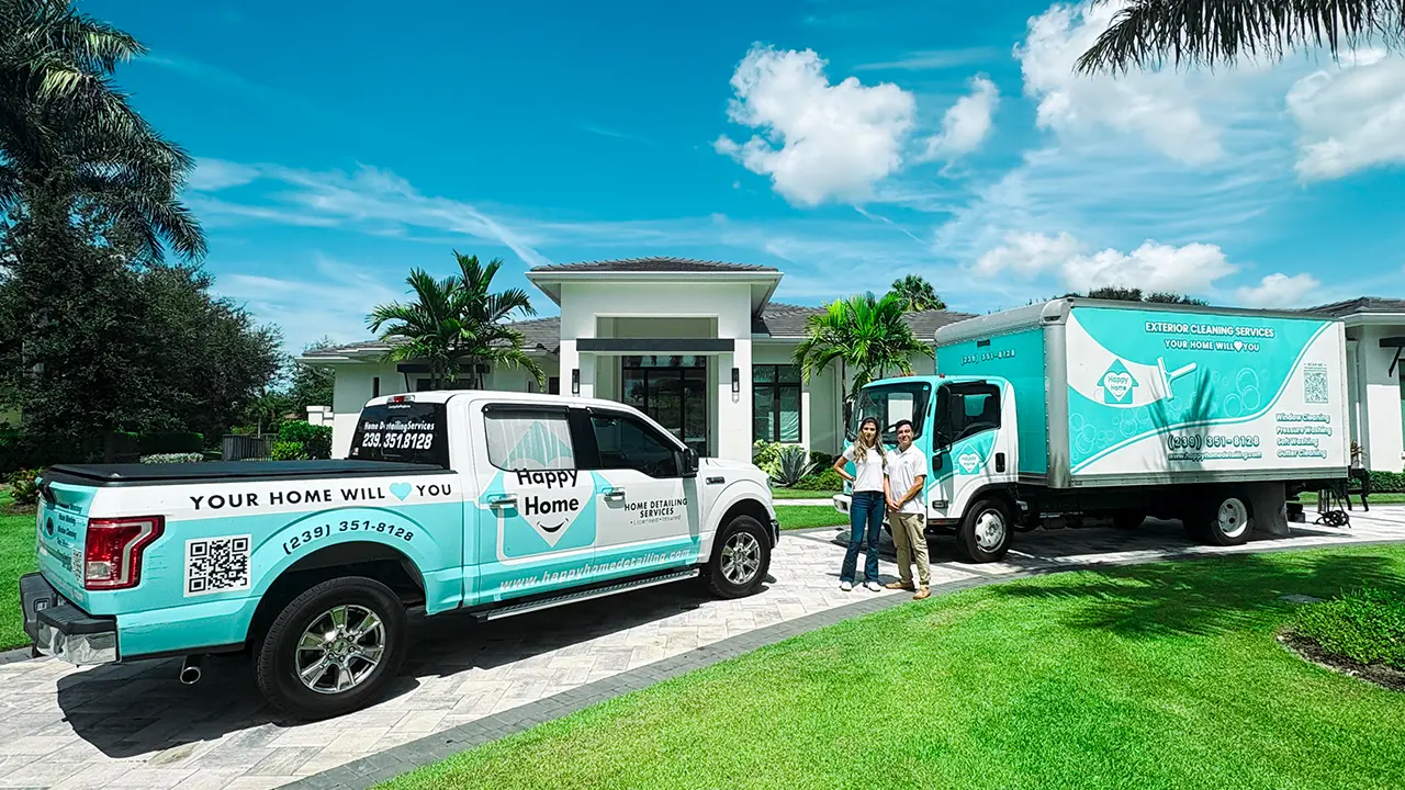 Owners Luis and Kristen next to their custom wrapped box truck and pickup truck.